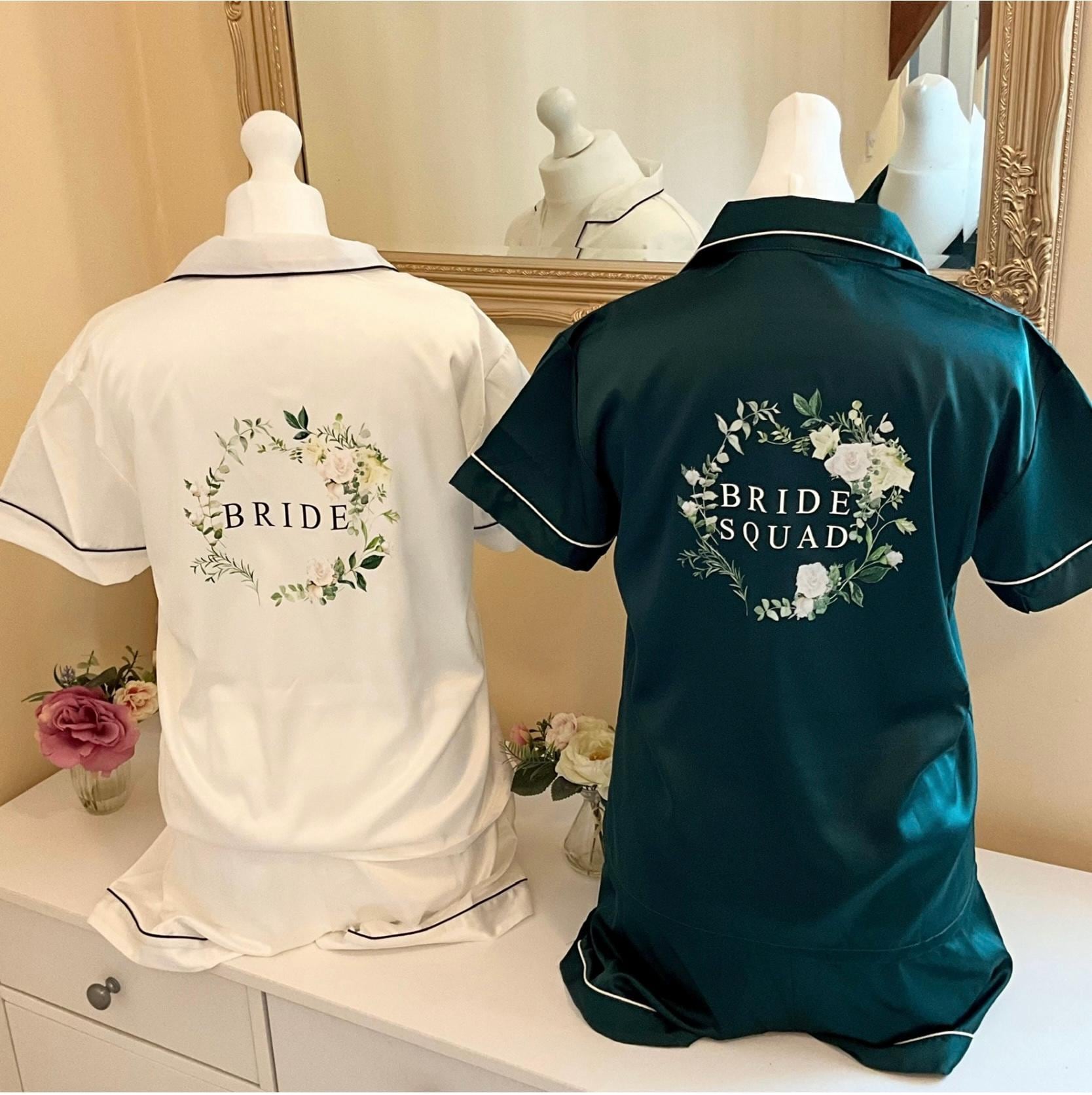 Two pajama sets on mannequins with 'BRIDE' and 'BRIDE SQUAD' text, one white and one green, against a neutral background.